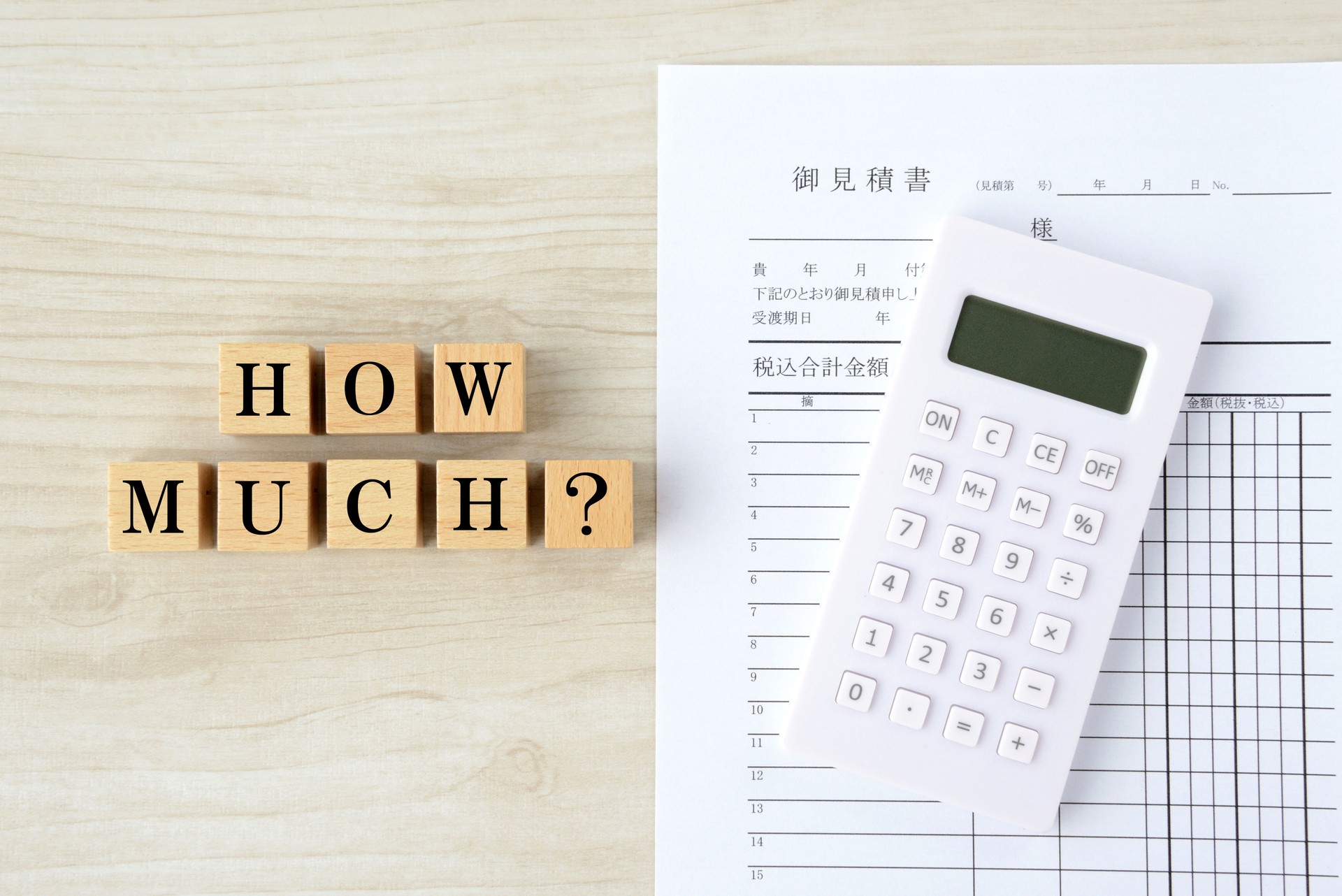 Japanese quotation and wooden blocks with "HOW MUCH?" word